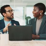 Man and woman talking in office