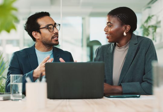 Man and woman talking in office