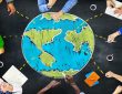 People sitting around drawing of globe