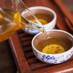 Cropped shot of pouring tea in traditional chinese teaware.