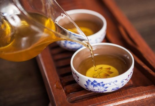 Cropped shot of pouring tea in traditional chinese teaware.