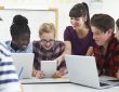 Teenage Students With Teacher In IT Class