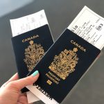 Person holding passports in hand