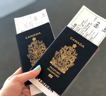 Person holding passports in hand