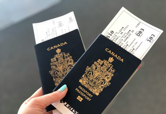 Person holding passports in hand