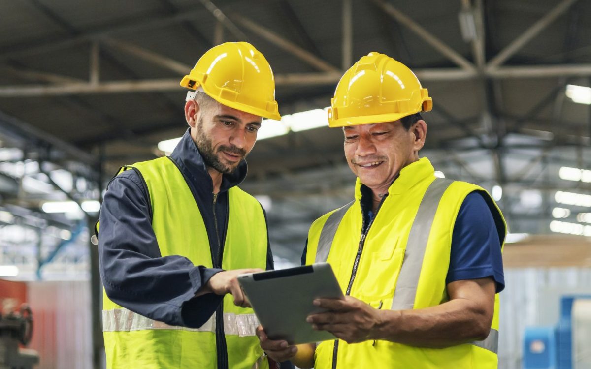 two engineers look projects and planning with tablet mobile in factory