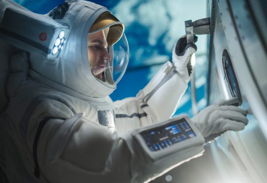 Astronaut in suit working on space station