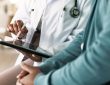 Closeup of hands of doctor looking at tablet
