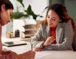 Two people looking at document in office