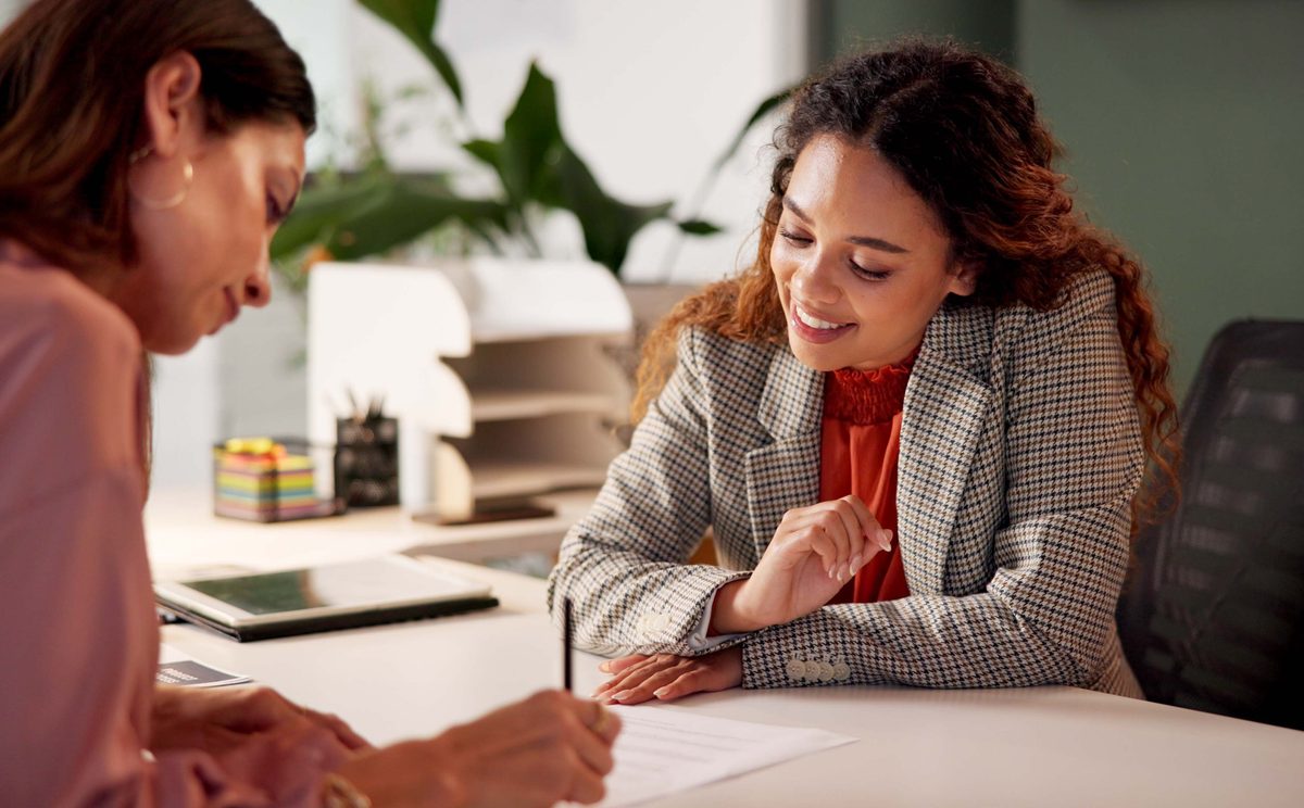 Two people looking at document in office