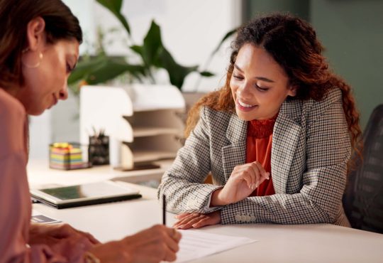 Two people looking at document in office