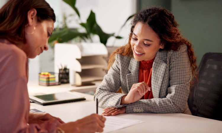 Two people looking at document in office