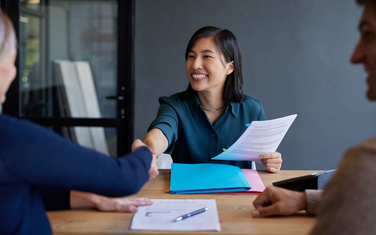 Candidate shakes hand with interviewer during job interview