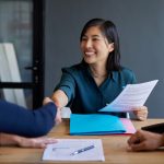 Candidate shakes hand with interviewer during job interview