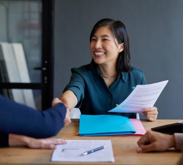 Candidate shakes hand with interviewer during job interview
