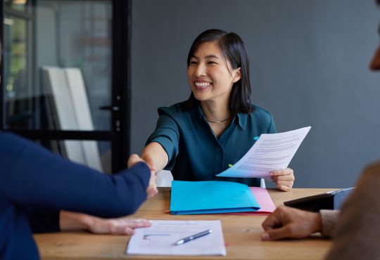 Candidate shakes hand with interviewer during job interview