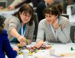 Two Cannexus attendees participate in a LEGO-based activity.