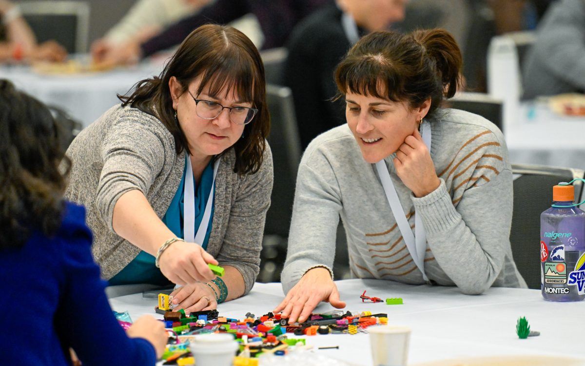 Two Cannexus attendees participate in a LEGO-based activity.