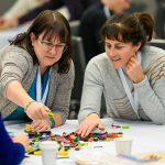 Two Cannexus attendees participate in a LEGO-based activity.