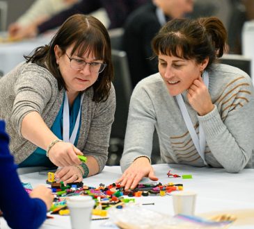 Two Cannexus attendees participate in a LEGO-based activity.