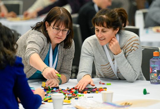 Two Cannexus attendees participate in a LEGO-based activity.
