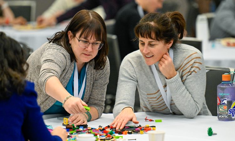 Two Cannexus attendees participate in a LEGO-based activity.