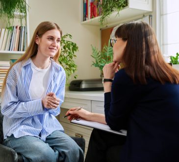 Teen talking to school counsellor in office