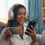 Woman listening on headphones while drinking tea