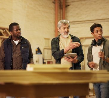 Workshop, men and group with tablet, carpenter or discussion with research, woodworking or technique. People, mature mentor and review of info