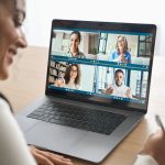 African American female student having video call videoconference on laptop. stock photo