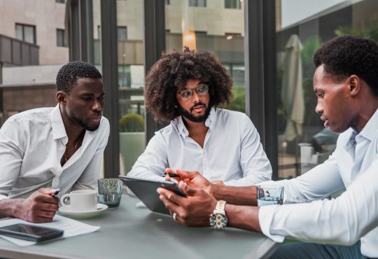 Multiracial business people working outdoor using digital tablet