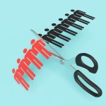 Scissors cutting a paper craft of a row of human shaped outline on blue background. Illustration of the concept of layoff and downsizing of staff