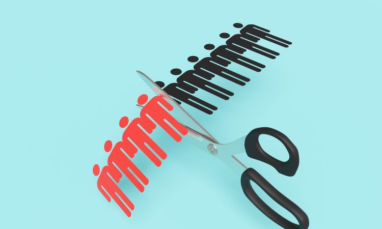 Scissors cutting a paper craft of a row of human shaped outline on blue background. Illustration of the concept of layoff and downsizing of staff
