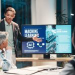 Businessman, screen and presentation in meeting for ai, machine learning or training in workshop office. Monitor, talk and team speaker with future technology for project development or idea at night