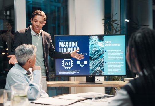 Businessman, screen and presentation in meeting for ai, machine learning or training in workshop office. Monitor, talk and team speaker with future technology for project development or idea at night
