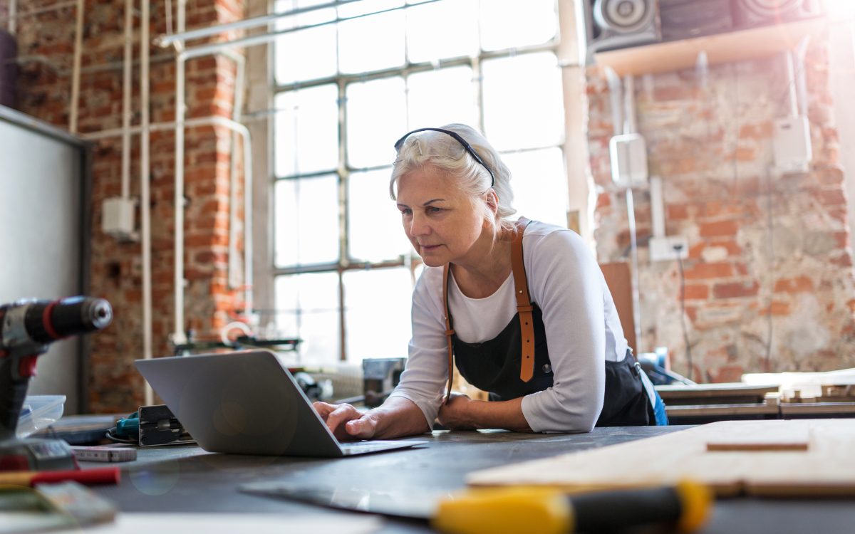 Confident senior woman working in workshop