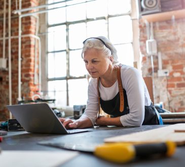 Confident senior woman working in workshop