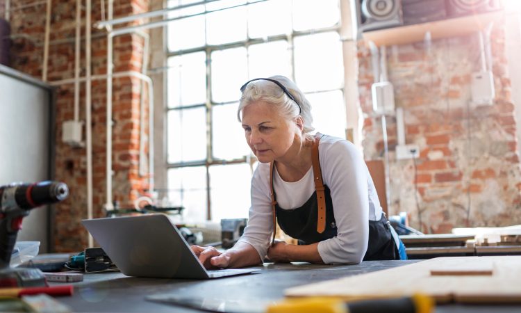 Confident senior woman working in workshop