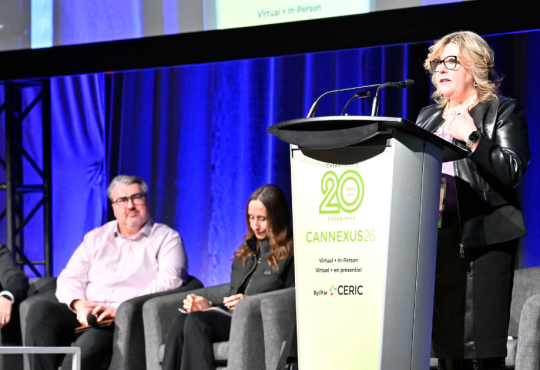 Dr. Tannis Goddard delivering a main stage speech at Cannexus26