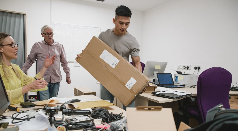 Colleagues are looking stressed as they set up the office for their new business.