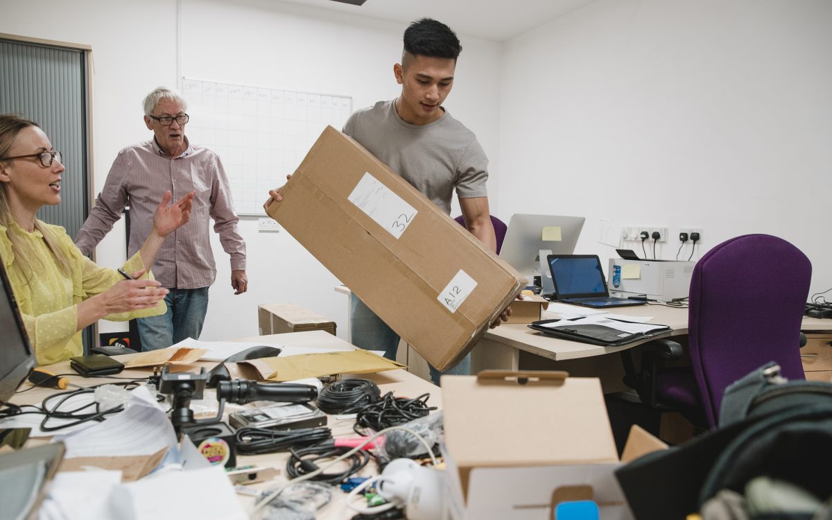 Colleagues are looking stressed as they set up the office for their new business.