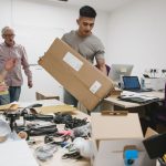 Colleagues are looking stressed as they set up the office for their new business.