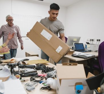 Colleagues are looking stressed as they set up the office for their new business.