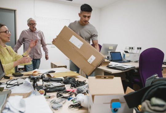 Colleagues are looking stressed as they set up the office for their new business.