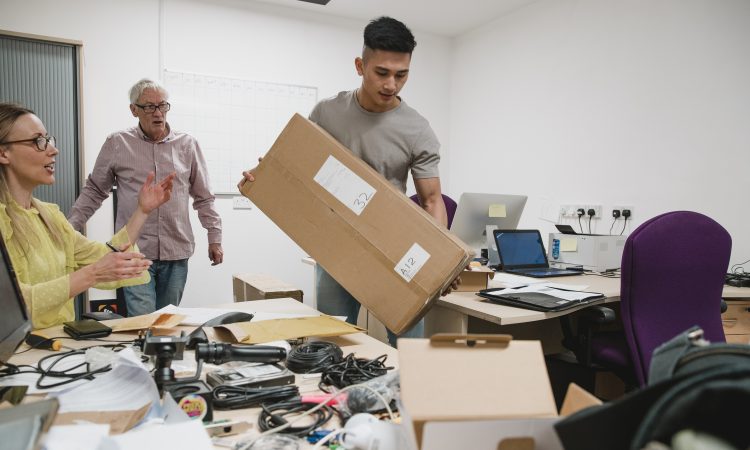 Colleagues are looking stressed as they set up the office for their new business.