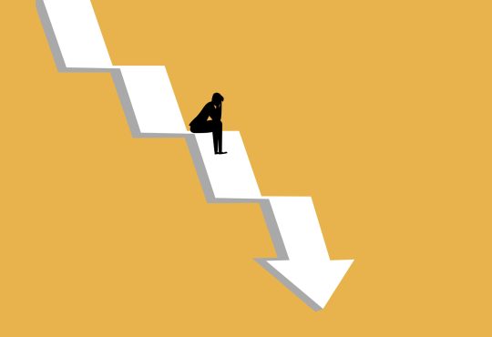businessman sat stressed on the crisis arrow