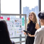 Team of caucasian entrepreneur are having a team meeting for project for marketing and sale management with skyscraper view for business startup and education
