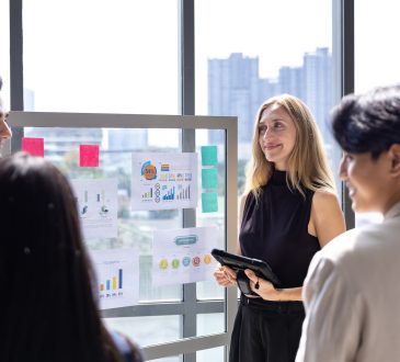 Team of caucasian entrepreneur are having a team meeting for project for marketing and sale management with skyscraper view for business startup and education